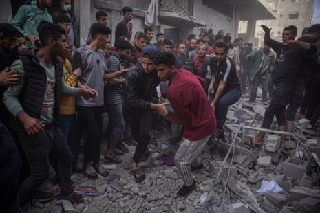 Injured Palestinian people are carried after Israeli bombing in the Al-Amal neighbourhood, west of Khan Yunis Governorate, south of the Gaza Strip.