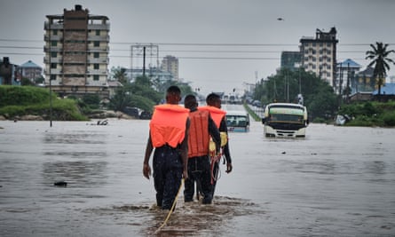 Rescuers make their way through flood water in Jangwani, Tanzania