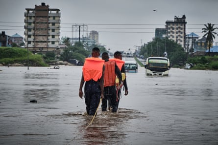Rescuers make their way through flooded streets in Jangwani, Dar Es Salaam