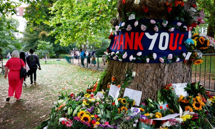 Flowers and messages are left in Green Park on Sunday.