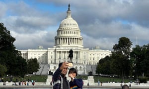 A couple taking a selfie front of the US Capitol Building.