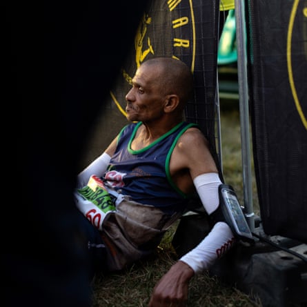 An exhausted runner rests shortly after crossing the finish line
