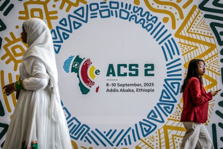 Delegates walk past a poster at the summit in Addis Ababa.