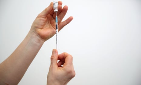 Hands preparing a dose of Covid vaccine