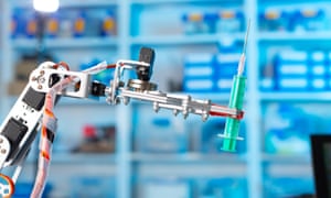 Robot arm holding medical syringe.