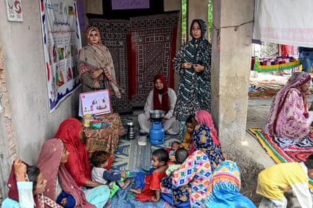 Community health workers teaching mothers how to prepare nutritious meals for their children during a Unicef nutrition programme.