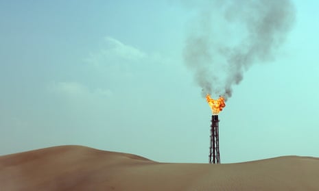 A flame above the desert at a gas well in Qatar