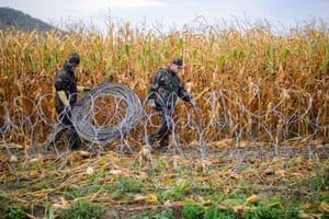 Hungarian soldiers set up a razor-wire fence on the Slovenian-Hungarian border in Pince, Slovenia.