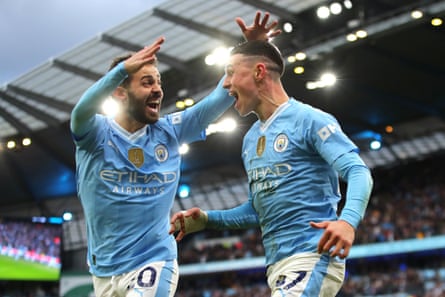 3 March 2024Phil Foden (right) and Bernardo Silva of Manchester City celebrate the team’s second goal against Manchester United at the Etihad Stadium. City won 3-1.