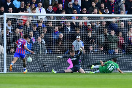 William Osula on the ground in front of goal as the ball soars past Dean Henderson into the net