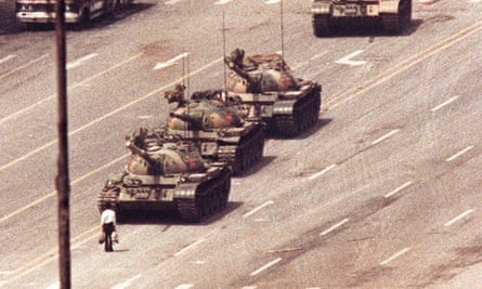 A man stands in front of a convoy of tanks in the Avenue of Eternal Peace in Beijing, 5 June 1989