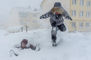 Yuzhno-Sakhalinsk, Russia: children play during a heavy snowstorm on Sakhalin Island
