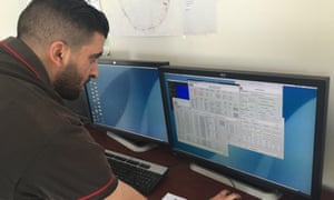 A worker looks at research data at the Sesame facility.