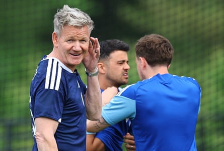 Ramsay in a football shirt next to two of the players