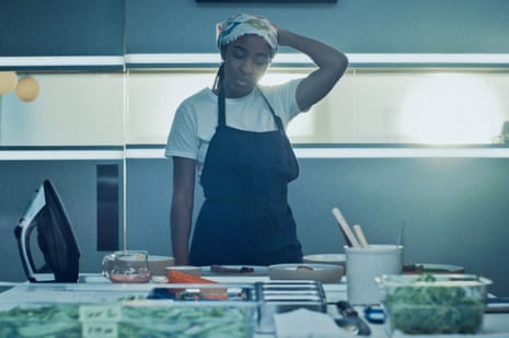 A young woman stare exasperatedly at a kitchen setup.