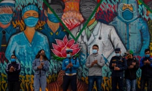Nepalese take part in a candle light vigil to pay respect to the people died due to the coronavirus disease in front of the mural depicting Covid-19 front line workers in Kathmandu on June 14.