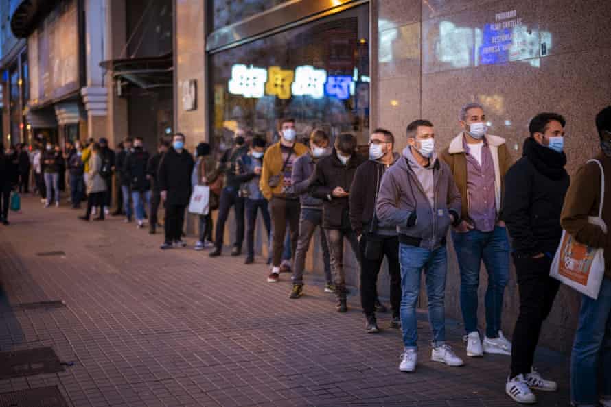 Volunteers line up as they wait to enter at a concert venue in Barcelona, Spain, Saturday, on 12 December, 2020. Eager for a live music show after months of social distancing, more than 1,000 Barcelona residents gathered Saturday to participate in a medical study to evaluate the effectiveness of same-day coronavirus screening to safely hold cultural events. After passing an antigen screening, 500 of the volunteers were randomly selected to enjoy a free concert inside Barcelona’s Apolo Theater.