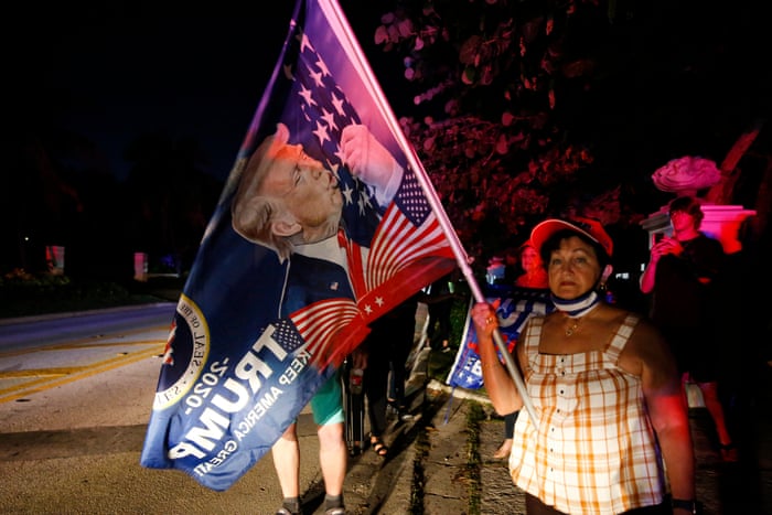 One woman holds a pro-Trump flag.