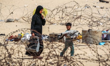 A woman and boy flee from Rafah in the southern Gaza Strip