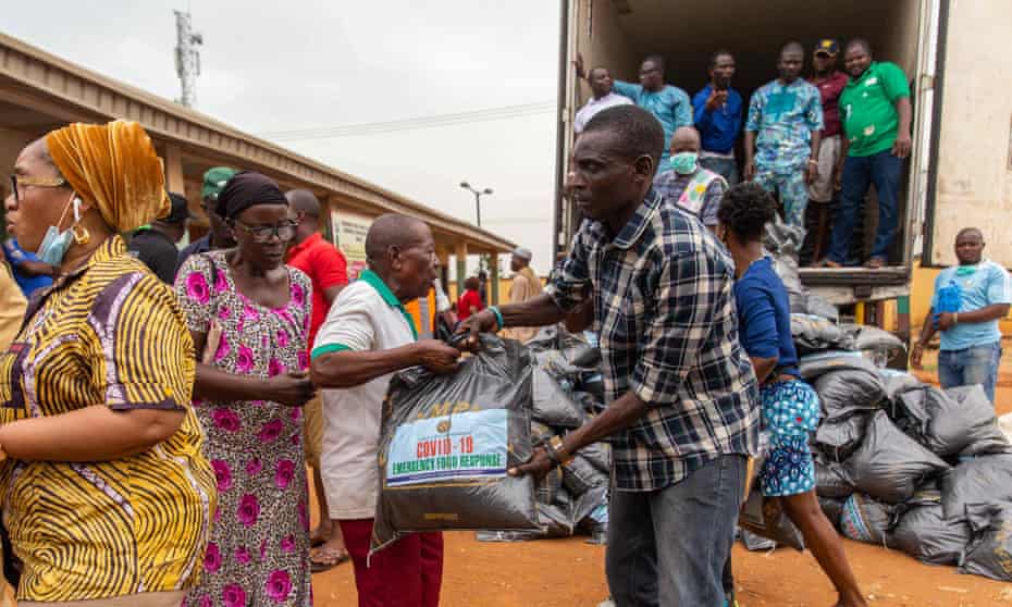 Lagos state officials hand out food relief bags as Nigeria tries to curb the spread of the coronavirus.