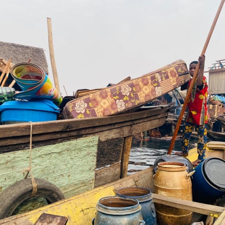 ‘They told us to leave. They didn’t tell us where to go’: the demolitions destroying homes and lives in Lagos A boy standing in a canoe loaded with barrels, holds a mattress on a boat loaded with household items