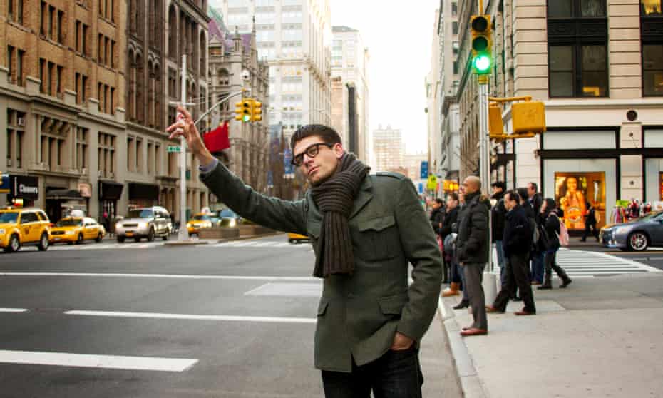 Man hailing a taxi on a New York street