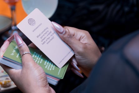 close up of a pair of hands sorting through a deck of cards