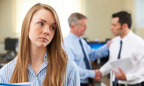 Unhappy woman with male colleague being congratulated