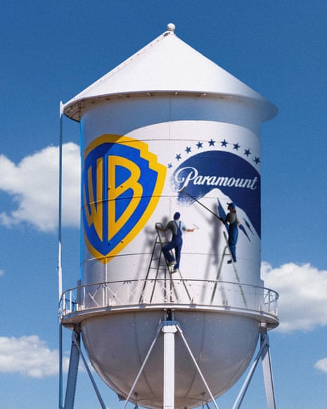 A water tower painted with Warner Bros and Paramount logos, with figures depicted painting them