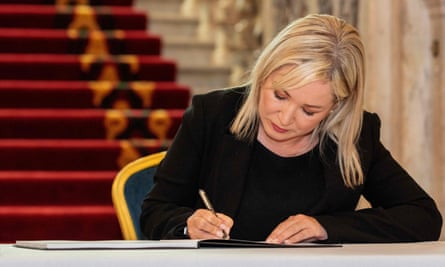 Michelle O’Neill signs a book of condolence for the Queen