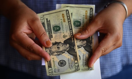 A woman counts US dollars