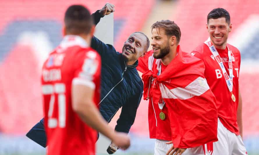 Nottingham Forest players with a cardboard cutout of Steve Cooper after their final win.
