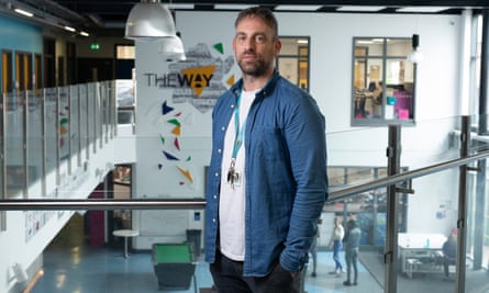 Paul Snape, wearing a blue shirt over a white T-shirt, poses for a picture inside the Way Youth Zone