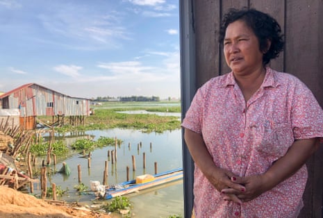 Kong Toeur, whose fishing plot was recently destroyed, stands in front of a neighbour’s home on Boeng Tamok lake.