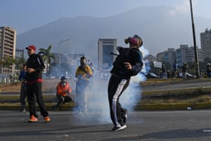 Protesters wear gas masks in Caracas