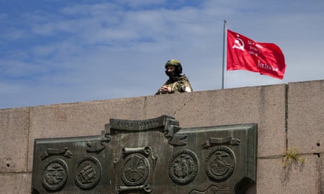 A Russian soldier guards an area at the Alley of Glory in Kherson, south Ukraine.