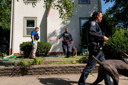 Police with K9 units sweep the neighborhood