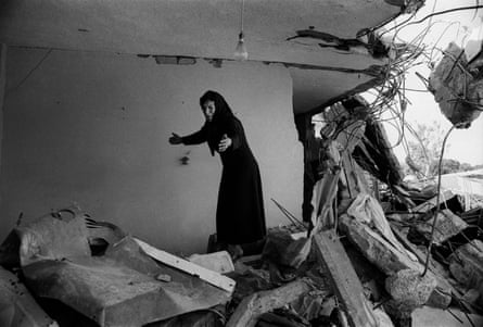 A Palestinian woman returning to the ruins of her house in Beirut in 1982.