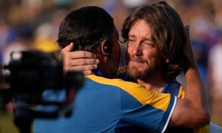 An emotional Tommy Fleetwood (right) embraces José María Olazábal on the 17th green.
