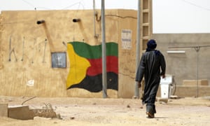 A man walks down a street in the Kidal region of Mali.