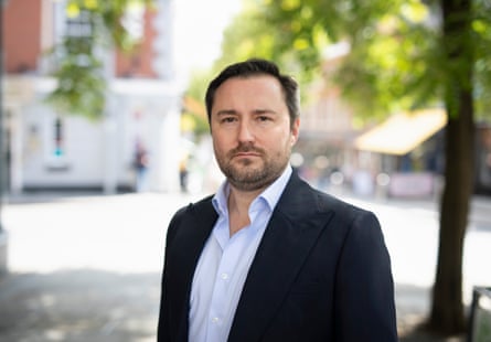A man wearing a suit and open-necked shirt