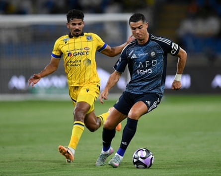 The Portugal and Al-Nassr forward Cristiano Ronaldo runs with the ball during a Saudi Pro League game against Al-Taawoun