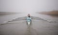The Cambridge University Boat Club women’s blue boat during a training session in freezing fog on the River Great Ouse in Cambridgeshire during February 2024.