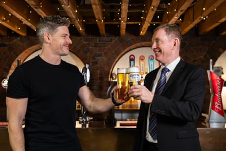 Brian Perkins and Chris Bryant hold pints of beer