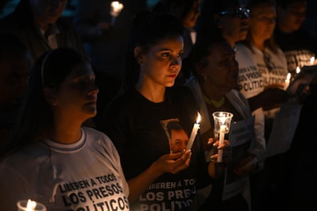 People light candles during a vigil to demand the release of political prisoners outside a prison in Venezuela