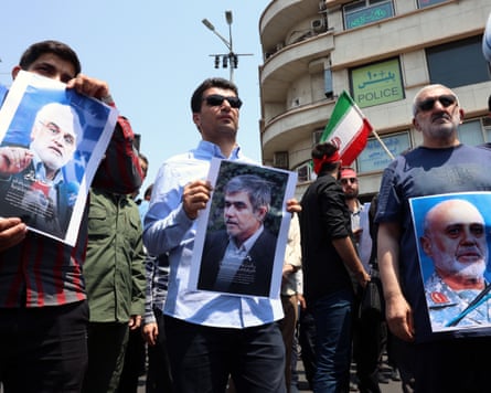 Iranians in Tehran hold posters of nuclear scientists and a Revolutionary Guards general killed in the Israeli airstrikes