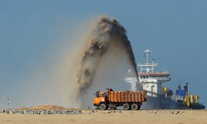 Reclaimed sand is sprayed at the Colombo International Financial City building site