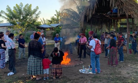An indigenous ceremony is conducted in the Petén department, Guatemala. Domingo Choc Che is second from right in red and black T-shirt.