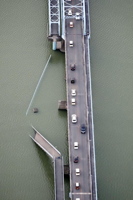 An aerial photo showing a section of a bridge collapsed into water.