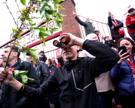 A fan is seen using binoculars outside the stadium prior to the Championship playoff semi between Middlesbrough and Southampton